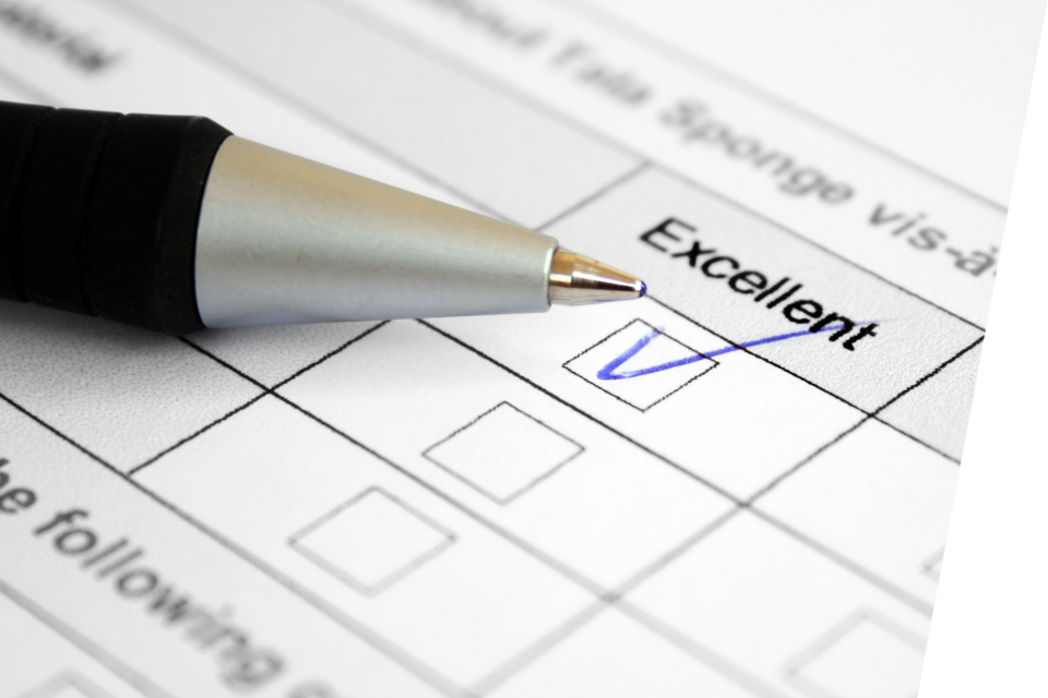 A pen rests on a survey next to a question with the "Excellent" box checked.