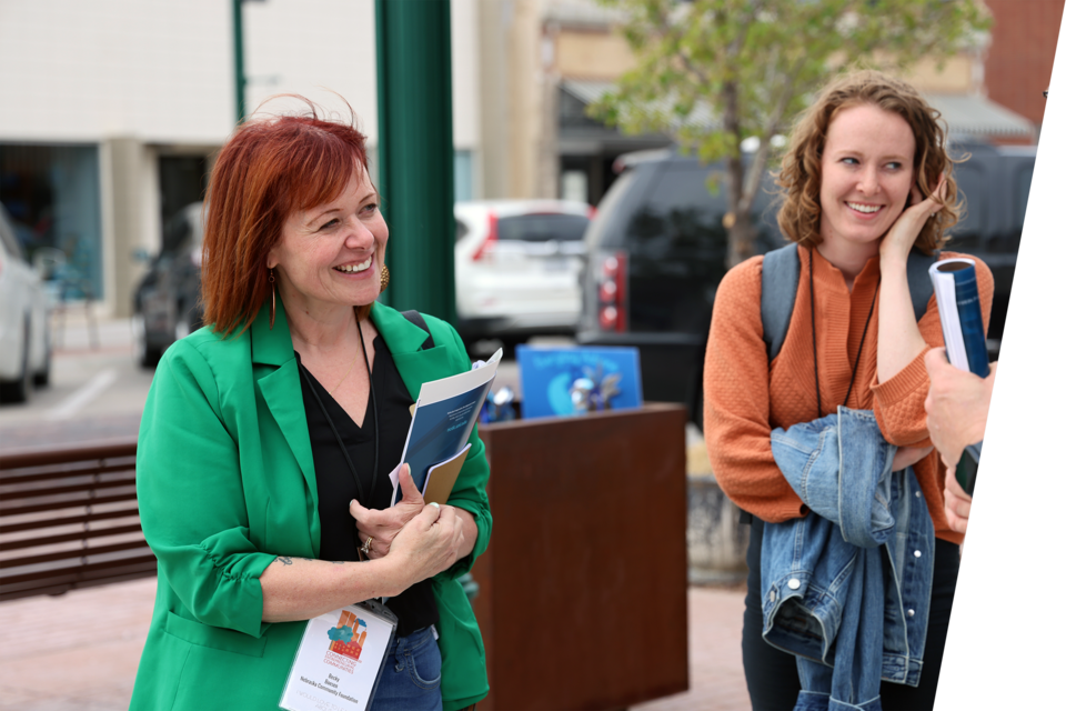 Two women converse on the street. Photo by Russell Shaffer