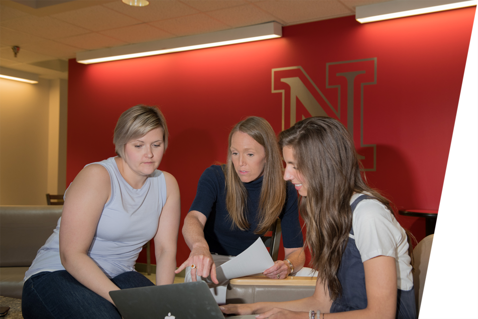 Professor Lindsay Hastings advises two students.