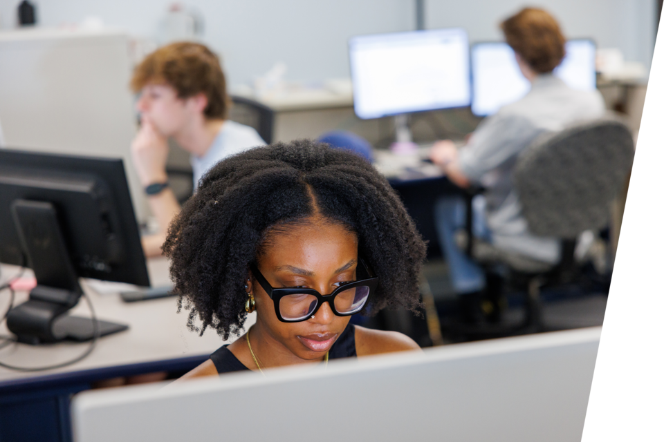 A woman looks at her computer.